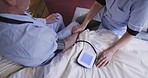Blood pressure, elderly patient and caregiver doing a health, wellness and medical exam. Retirement, nursing and senior care home with nurse helping with medic consulting and service for cardiology