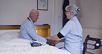 Healthcare, insurance or assisted living with a senior man and woman carer in a bedroom for a checkup. Medical, rehabilitation and recovery with a female caregiver consulting a male resident
