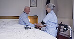 Senior man, rehab and medical caregiver checking pulse, blood pressure or sugar levels. Elderly male in checkup, visit or diabetic at home with woman nurse monitoring health and wellness in bedroom