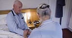 Healthcare, consultation and nurse with senior man checking his pulse in his bedroom at his house. Medical, nursing and female caregiver doing a checkup for a elderly guy in a retirement home.
