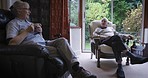 Senior couple, retirement and relax with conversation together, coffee break at house or nursing home. People, care and love in marriage with communication, health and wellness with retired lifestyle