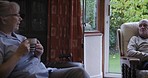 Senior people, retirement and relax with conversation, coffee break at house or nursing home. Old couple, care and love in marriage with communication, health and wellness with retired lifestyle