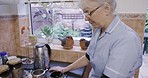 Kitchen, caregiver or nurse waiting for kettle for tea in cup at nursing home or rehabilitation center at breakfast time. Healthcare, support and elderly woman working in senior care making coffee.