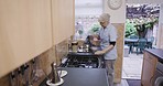 Kitchen, caregiver or nurse pouring kettle water in cup at nursing home or rehabilitation center at breakfast time. Healthcare, support and elderly woman working in senior care making tea or coffee.