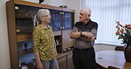Love, retirement and speaking with a senior couple in the living room of their home chatting together. Security, trust and support with a mature man and woman enjoying conversation while bonding
