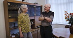 Love, retirement and talking with a mature couple in the living room of their home chatting together. Security, trust and support with a senior man and woman enjoying conversation while bonding