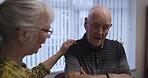 Love, retirement and talking with a senior couple in the living room of their home chatting together. Security, trust and support with a mature man and woman enjoying conversation while bonding