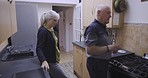 Real people, kitchen and senior couple talking while getting ready to cook food for a meal together. Conversation, happy and elderly man and woman in retirement preparing dinner in their home.