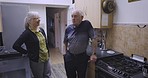 Senior couple, relax and talking in a kitchen, happy and smile while bonding in their home. Love, elderly and woman with man speaking, laughing and enjoy retirement, morning and relationship indoors