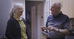Love, talking and senior couple relax in a kitchen, happy and smile while bonding in their home. Elderly, woman and man speaking, laughing and enjoying retirement, morning and relationship indoors