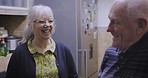 Happy, elderly couple and laughing In a kitchen, smile and bonding in their home together. Cheerful, seniors and woman with funny man, joke and humor while enjoying retired lifestyle in their house