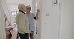 Retirement, thermostat and temperature with a woman nurse showing a man patient the control dial in his home. Assisted living, heating or switch with a female medicine professional and male resident