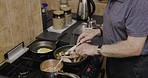 Elderly man, kitchen and dinner cooking of a senior person with vegetables and eggs on a stove. Home, health food and diet recipe of a male in retirement with apron and ingredients at a house