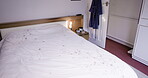 Empty bedroom, wood or comfort furniture for sleeping, rest or recovery in house, nursing home or retirement apartment. Bed, interior design or relax living space in property or real estate building
