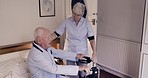 Nurse help senior man in bedroom for healthcare, disability assistance and medical care at nursing home. Support, retirement and caregiver helping sick and elderly patient from bed to wheelchair