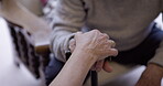 Hands, senior and people in care, support and grief due to cancer in retirement home and touching for comfort. Elderly, old and closeup of mature couple with trust or hope and walking stick as help