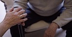 Couple, hands and support for man with disability, depression and empathy while bonding in a home. Love, trust and hand of elderly woman on disabled man for encouragement, unity or stroke recovery 