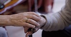 Couple, hands and comfort of support for man with disability, empathy and kindness in their home. Love, trust and hand of elderly woman on disabled man for encouragement, unity or stroke recovery 