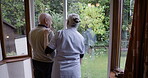 Homecare, garden and senior people talking of growth, investment and plants for backyard wellness with caregiver. Real elderly man, nurse or woman with support, conversation or backyard ideas in rear