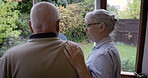 Assisted living, garden and back with a senior man and caregiver nurse standing by a window in a retirement home. Healthcare, medical and care with a woman nurse and male patient in a house