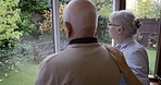 Back, window and senior couple, talking and retirement with conversation, loving and bonding. Love, man and woman with happiness, glass and retired with peace, speaking or relationship in living room