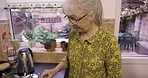 Kitchen, coffee and old woman chatting man with cup at breakfast time in home, grandma making beverage for grandpa. Morning, tea and senior couple enjoying retirement, drink and marriage with love.