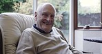 Senior man, portrait and smile of an elderly person in a retirement home sofa with happiness. Happy, old person and relaxing male on a living room couch in a lounge smiling with joy alone in a house