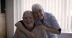 Old couple, portrait and hug of senior people with smile, love and marriage care in retirement. Home, smile and happiness of a senior woman and man together feeling relax about life in a house 