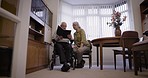 Senior couple with album, memory and life together, retirement and relax with communication and pictures. Love, care and retired people in nursing home, memories and talking with old man and woman