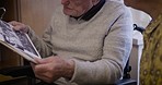 Conversation, senior and couple looking at photos for love, memory and nostalgia in home. Bonding, retirement and elderly man and woman with an album with pictures to reminisce together in the lounge