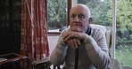 Sad, depression and senior man in a home, thinking with mental health and anxiety in a chair. Idea, stress and elderly person with fear, lonely and missing family while depressed with alzheimer