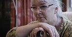 Alzheimer, thinking and face of senior woman in nursing home with memories, nostalgia and thoughtful. Retirement, mental health and closeup of sad, lonely and depressed elderly lady in living room