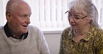 talking, relax and senior couple in a living room, happy and smile while enjoying a peaceful morning in their home. Love, elderly and old man with woman in lounge, content and satisfied in retirement