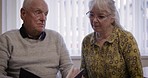 Senior couple, relax book and reading story together, bonding and enjoying quality time in house. Love, storytelling and elderly retired man and woman study or read novel, literature or books in home
