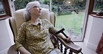 Alzheimer, retirement and senior woman in nursing home by window with memories, nostalgia and thoughtful. Mental health, depression and sad, lonely and elderly lady sitting on chair in living room