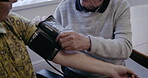 Health, blood pressure and arm with an old couple together in their retirement home for a wellness checkup. Medical, cardiovascular or cholesterol with a mature man and woman testing for hypertension