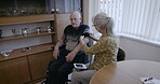 Blood pressure cuff, senior couple and house check for medical test, cholesterol and hypertension. Old people, arm pulse and monitor heart healthcare, diabetes or cardiovascular wellness in apartment