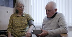 Health, blood pressure and wheelchair with an old couple together in their retirement home for wellness. Medical, disability and cholesterol with a mature man and woman testing for hypertension