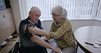 Couple, health and blood pressure cuff on arm for medical test, cholesterol and hypertension. Old people, pulse and monitor heart, diabetes risk and cardiovascular wellness in apartment for support 