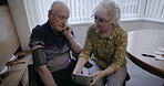 Couple, health and blood pressure machine in home for cholesterol, elderly support and hypertension. Old people, pulse and monitor heart, diabetes risk and cardiovascular wellness test in apartment 