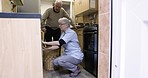 Laundry, housekeeper or caregiver helping old man with disability at washing machine in kitchen. House work, retirement and senior woman volunteer with grandpa with home chores and cleaning clothing.