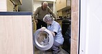 Cleaner, cleaning and senior couple doing laundry, loading clothes and housework in washing machine. Working, help and elderly man and woman talking and sorting clothing for chores and housekeeping