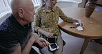 Senior man, rehab and caregiver checking prescription notes or monitoring health conditions of patient at home. Elderly male with nurse in rehabilitation or healthcare centre for checkup on illness