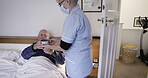 Covid, coffee or retirement with a nurse and patient lying in the bedroom of his home. Healthcare, morning and service with a woman medicine professional and senior man in an assisted living bed