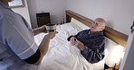 Nurse giving a senior man coffee in bed for assistance or homecare for sick or disabled person. Healthcare, helping and caregiver with cup of cappuccino for elderly guy in nursing or retirement home.