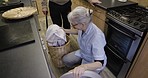 Housework, kitchen and senior woman doing laundry together in the retirement home for chores. Cleaning, household and elderly man and woman washing their daily clothes in a machine at their house.