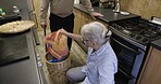 Laundry, elderly care and caregiver with old man with disability helping at washing machine in kitchen. House work, retirement and senior woman with grandpa with home chores and cleaning clothing.
