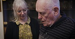 Caregiver, help and elderly man walk in a retirement home and disabled in a nursing house. Elderly, pensioner and nurse assist mature male with care, support and healthcare or physiotherapy