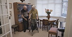 Couple, senior and help woman with walker in a home disabled in a nursing house. Elderly, pensioner and man assist mature female walk with care, support and healthcare or physiotherapy in retirement
