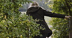Woman, travel and walking over fence in the countryside for nature adventure, trip or exploring. Female tourist, explorer or traveler taking a walk in the forest through obstacle for holiday weekend